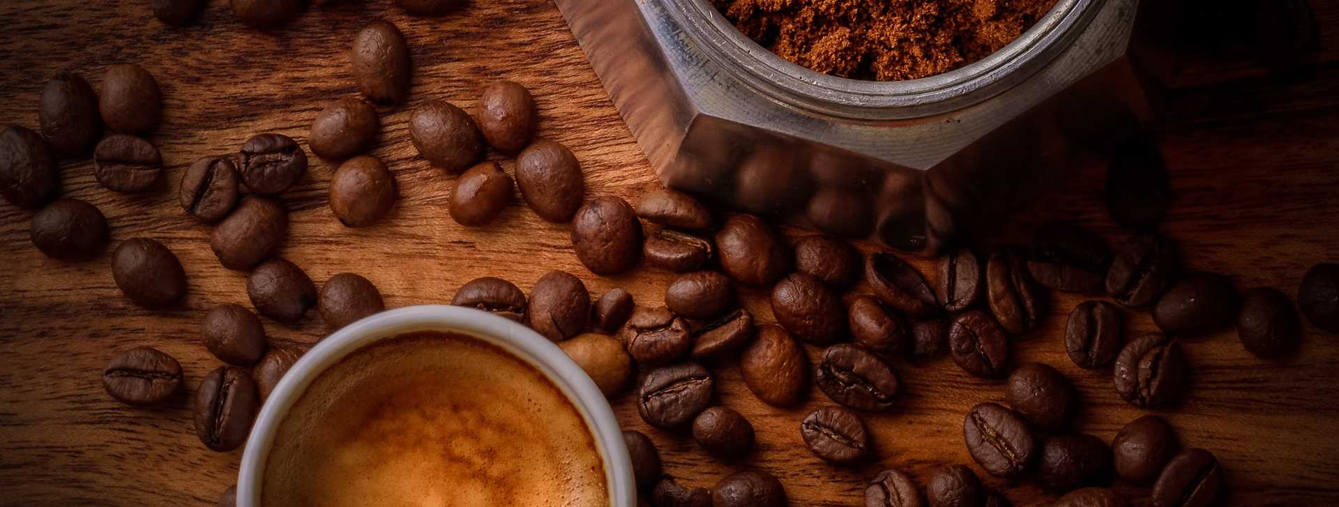 Coffee beans and ground coffee on a wood countertop